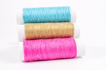 multicolor sewing threads on white background,