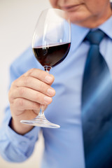close up of senior man drinking wine from glass