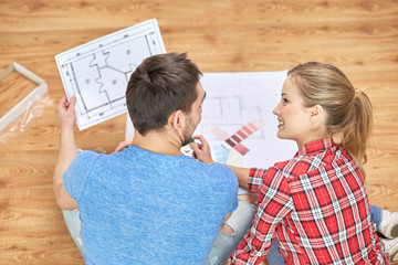 happy couple with blueprint and color samples