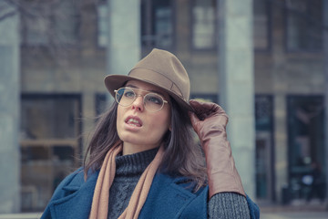 Beautiful young brunette posing in the city streets