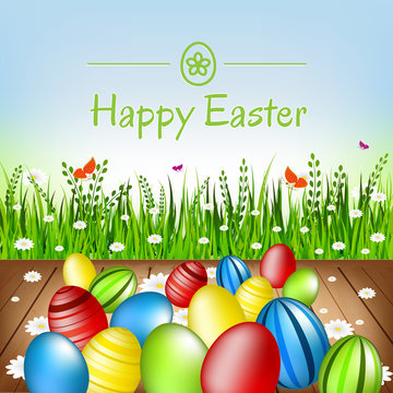 Easter card. Easter eggs, flowers and green grass.
