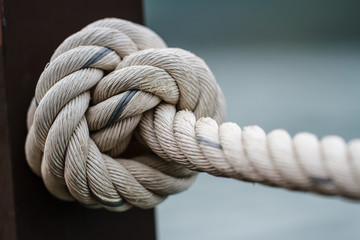 White rope tied into a knot.