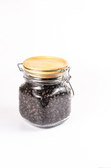 roasted coffee beans in glass bottle