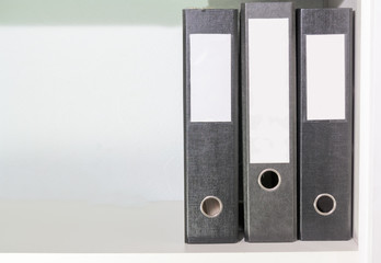 Folders for documents on a book shelf