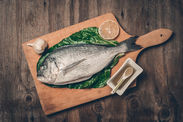 Fresh sea bream wooden board