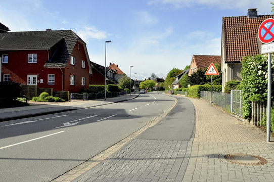 Small cottages and asphalt road in Germany