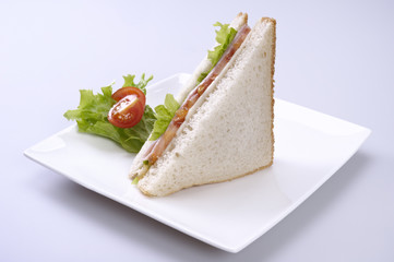 Ham and cheese sandwich with tomato and lettuce