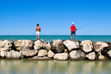 Fototapeta na wymiar Two fishermen at the sea