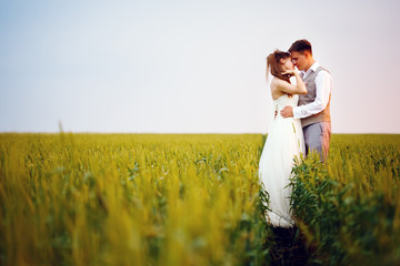 Happy young wedding couple kissing