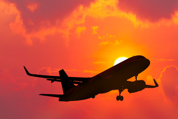 Fototapeta na wymiar air plane flying with sunset