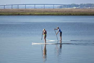 Fototapeta na wymiar couple stand up paddleboarding