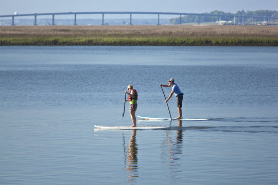 couple stand up paddleboarding