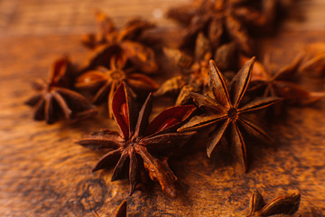 Cinnamon sticks with anise star on wooden background
