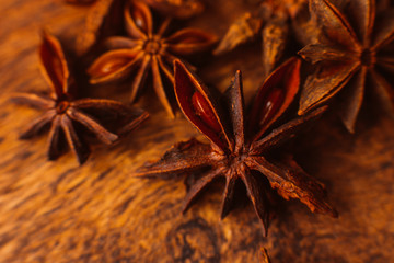 Cinnamon sticks with anise star on wooden background