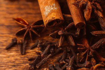 Cinnamon sticks with anise star on wooden background