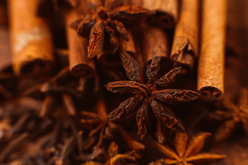 Cinnamon sticks with anise star on wooden background