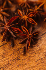 Cinnamon sticks with anise star on wooden background