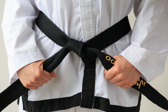 Taekwon-do woman with black belt and getting ready for training.