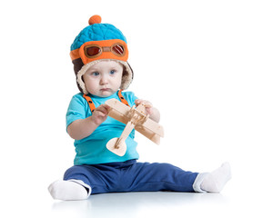 baby boy pilot and with wooden airplane toy