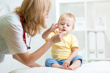 doctor giving medicament with a spoon