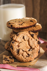 Pile of chocolate cookies with a glass of milk