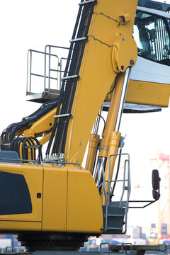Large tracked excavator working a steel pile at a metal recycle