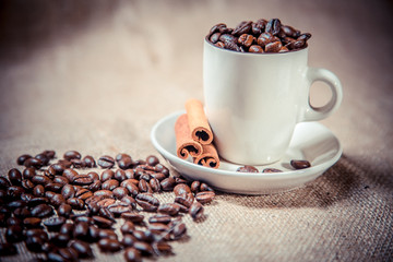 cup of coffee beans on sackcloth