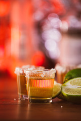 tequila , lime and salt on wooden table