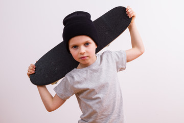 Young boy in a  hat and skateboard