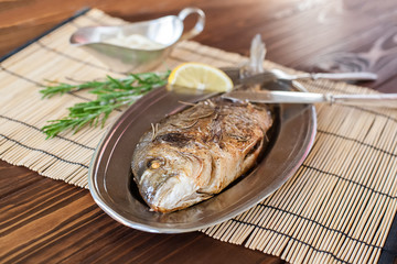Fried dorado on the plate
