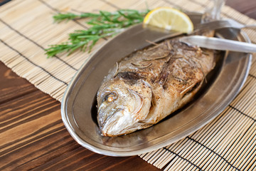 Fried dorado on the plate