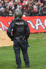 Police officer control fans to prevent football violence