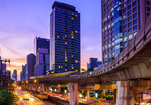 cityscape at dusk with sky train