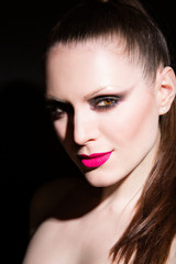 Fototapeta na wymiar woman with pink lips on black background. in studio