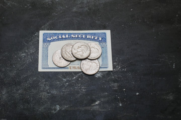 Social security card with coins on it
