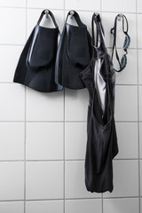 Swimming gear on tile wall