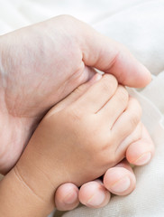Parent and daughter holding hand
