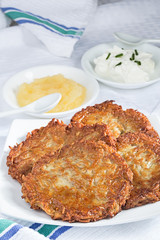 Homemade potato pancakes with applesauce and sour cream