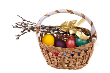 Fototapeta na wymiar Easter catkins and basket with Easter eggs .