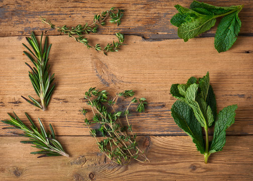 Freshly clipped herbs on wooden background