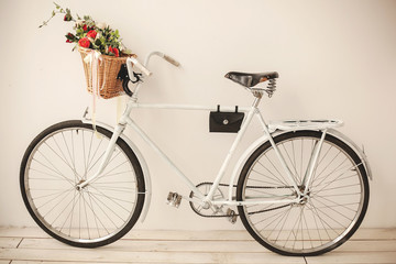 Fototapeta na wymiar White retro bicycle on white wooden floor