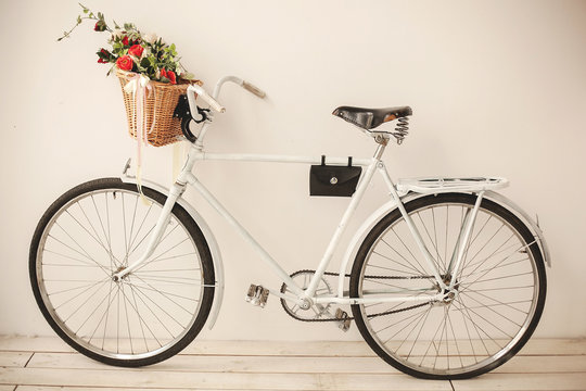 White retro bicycle on white wooden floor