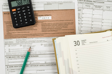 Polish tax form with pencil, calendar and calculator