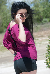 Naklejka premium Outdoor of a fashion teen with shorts and sunglasses