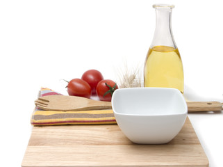 wooden board, olive oil with cherry tomatoes on the kitchen