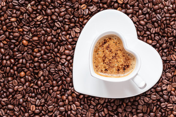 white coffee cup heart shaped with cappucino