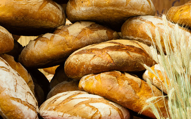 many brown rustic fresh rye bread loaves