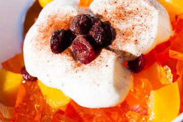 Fruit jelly with whipped cream and raisin