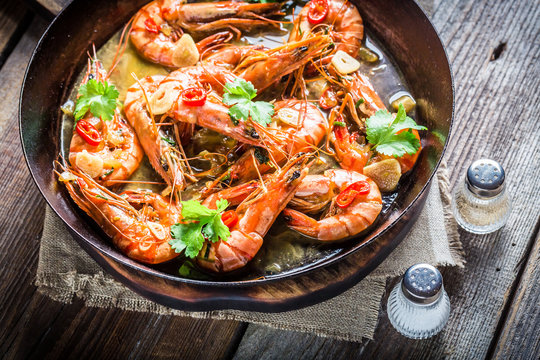 Tasty shrimps served on hot pan