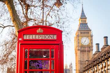 Fototapeta na wymiar Famous red telephone box with Big Ben on background